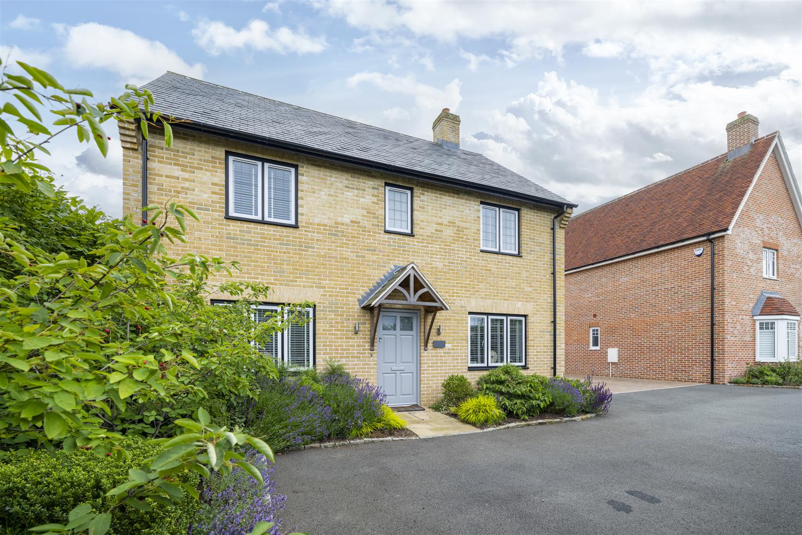 Modern two-storey brick house with landscaped front garden